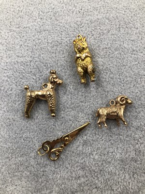 Lot 313 - Four gold charms. A 9ct hallmarked gold ram, a...
