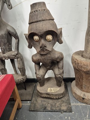 Lot 568 - An indonesian carved short squatting figure of...