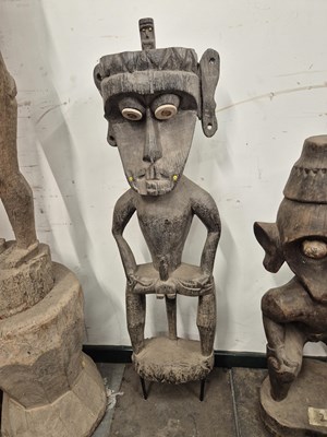 Lot 569 - An indonesian carved short squatting figure of...