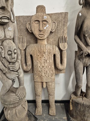 Lot 572 - A carved indonesian figure of a man wering a...
