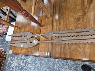 Lot 650 - Two African carved paddle spears.