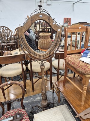 Lot 651 - A carved hardwood and wrought iron mirror...