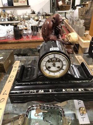 Lot 1515 - A black slate cased mantel clock striking on a...