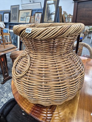Lot 673 - A large wicker basket.
