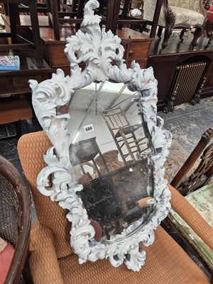 Lot 688 - A decorative framed wall mirror.