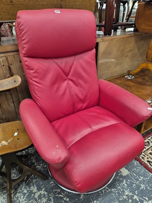 Lot 694 - A Swivel armchair and matching stool.