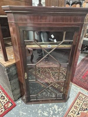 Lot 698 - An antique mahogany glazed corner cabinet.