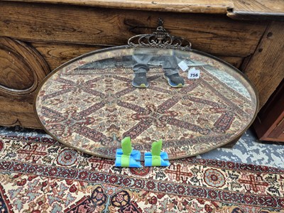 Lot 756 - An oval wall mirror.