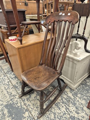 Lot 773 - an antique slat back rocking chair.