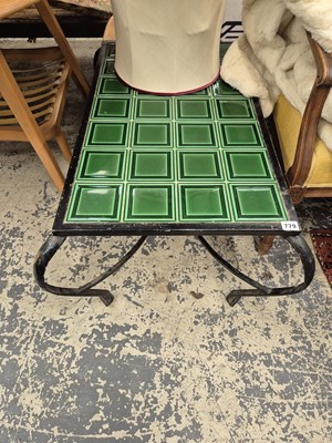Lot 779 - A tile topped wrought iron coffee table.