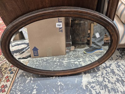 Lot 797 - An oval wall mirror.