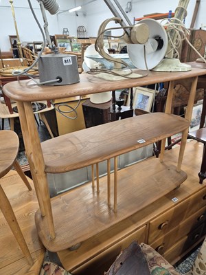 Lot 810 - An Ercol pale elm three tier wheeled stand.
