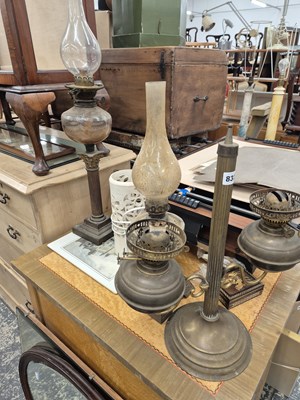 Lot 832 - Three oil lamps and a retro table lamp.
