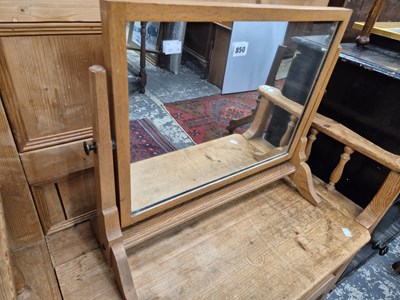 Lot 850 - An arts and crafts style oak swing mirror.