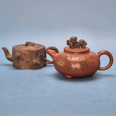 Lot 355 - Two Yixing tea pots, the darker red ware...