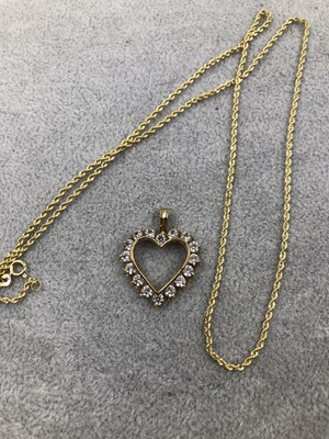 Lot 403 - A 9ct hallmarked gold open heart pendant set...