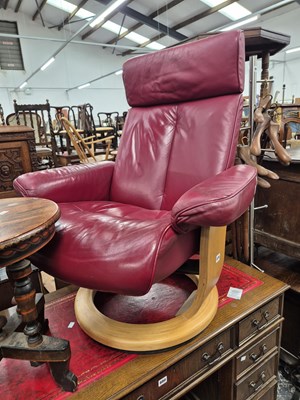 Lot 879 - A Leather reclining swivel armchair and...