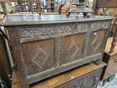 Lot 883 - An 18th century oak coffer with triple carved...