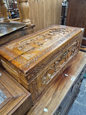 Lot 927 - An oriental carved camphor wood trunk.