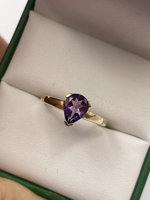 Lot 273 - A 9ct hallmarked gold pendeloque-cut amethyst...