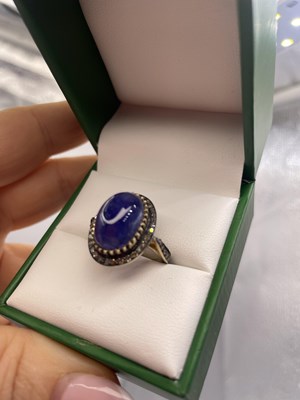 Lot 310 - A large cabochon tanzanite and rose-cut...