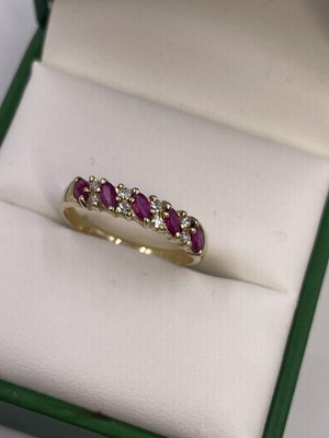 Lot 289 - A 9ct hallmarked gold nine-stone marquise ruby...