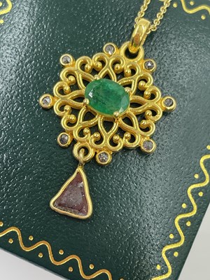 Lot 293 - A floral pendant in silver gilt set with an...