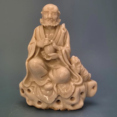 Lot 377 - A blanc de Chine figure of an immortal seated...