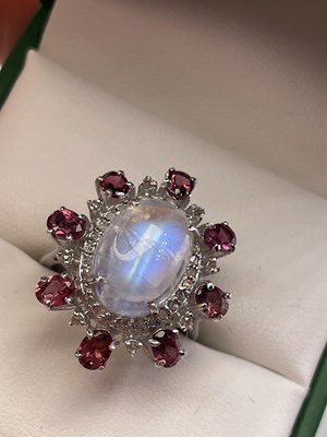Lot 303 - A large cabochon rainbow moonstone, pink...