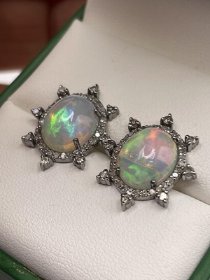 Lot 311 - A pair of opal cabochon and diamond sunburst...