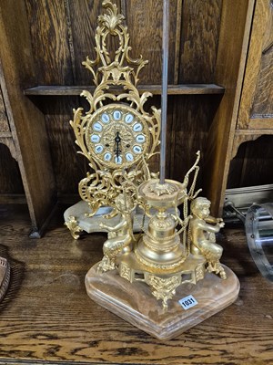 Lot 1031 - A gilt brass mantle clock and a similar brass...