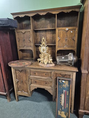 Lot 1030 - An early 20th century oak dresser and rack.