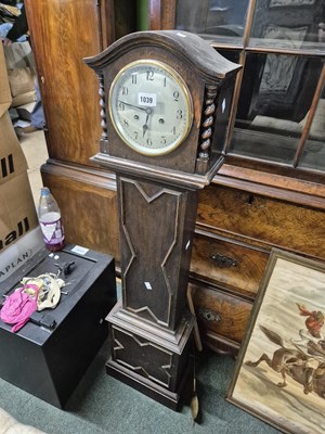 Lot 1039 - An oak cased granddaughter clock.