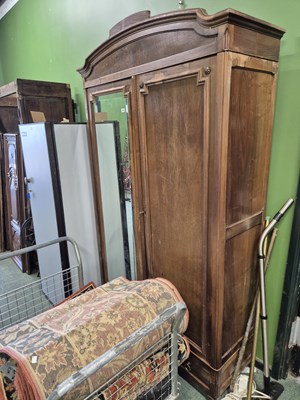 Lot 1040 - A French walnut mirror door wardrobe. Prov....
