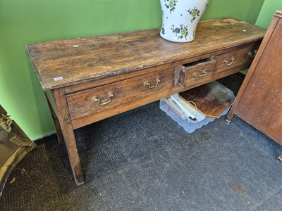 Lot 1047 - A Georgian country pine three drawer dresser...