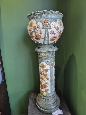Lot 1050 - A Pottery jardiniere on stand. H overall 96cms
