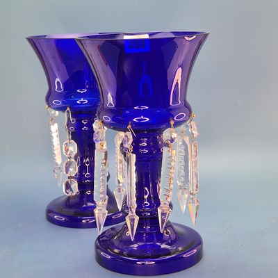 Lot 389 - A pair of blue glass lustres, the drops hung...