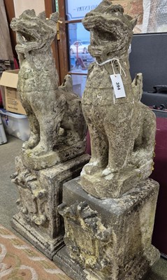 Lot 394 - A pair of reconstituted stone oriental lion...