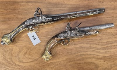 Lot 398 - Two flintlock pistols, one with carved wood...