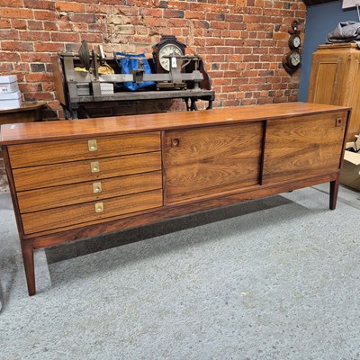 Lot 424 - A 1970's rosewood side board with four drawers...