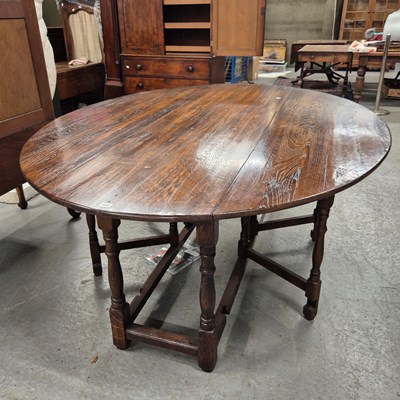 Lot 441 - A 19th century oak oval drop flap table on...