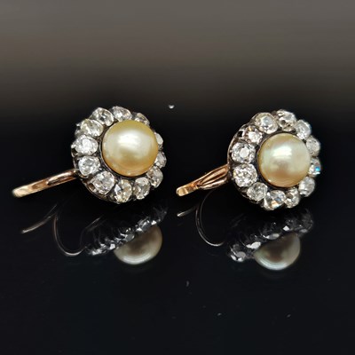 Lot 1 - A pair of antique diamond and pearl cluster...