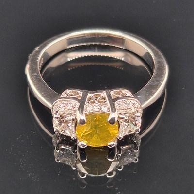 Lot 19 - A certificated fancy yellow diamond and...
