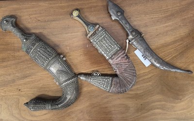 Lot 445 - Two Arabian daggers in white metal mounted...