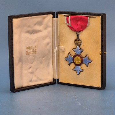 Lot 447 - A CBE badge and ribbon in a Garrard's case