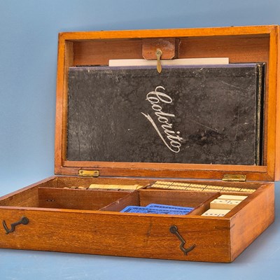 Lot 453 - A mahogany games compendium comprising: chess,...