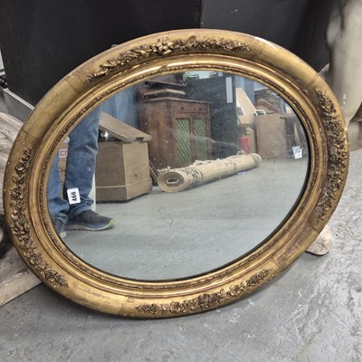 Lot 466 - An oval mirror in a 19th century gilt wood and...