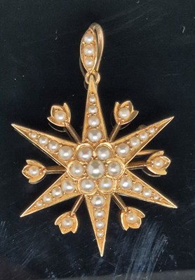 Lot 25 - An antique pearl set starburst pendant brooch...