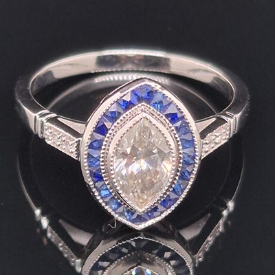 Lot 46 - A navette-shaped ring set with a marquise...