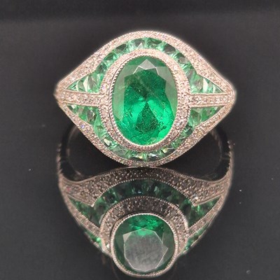 Lot 52 - An emerald and diamond Art Deco-style ring....